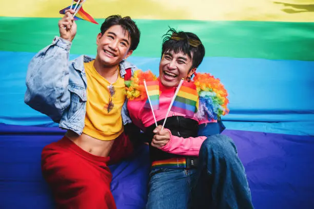 Couple celebrating equality with rainbow flags