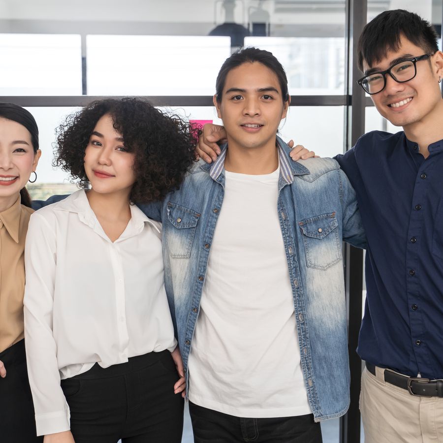 Four young people of different backgrounds standing together
