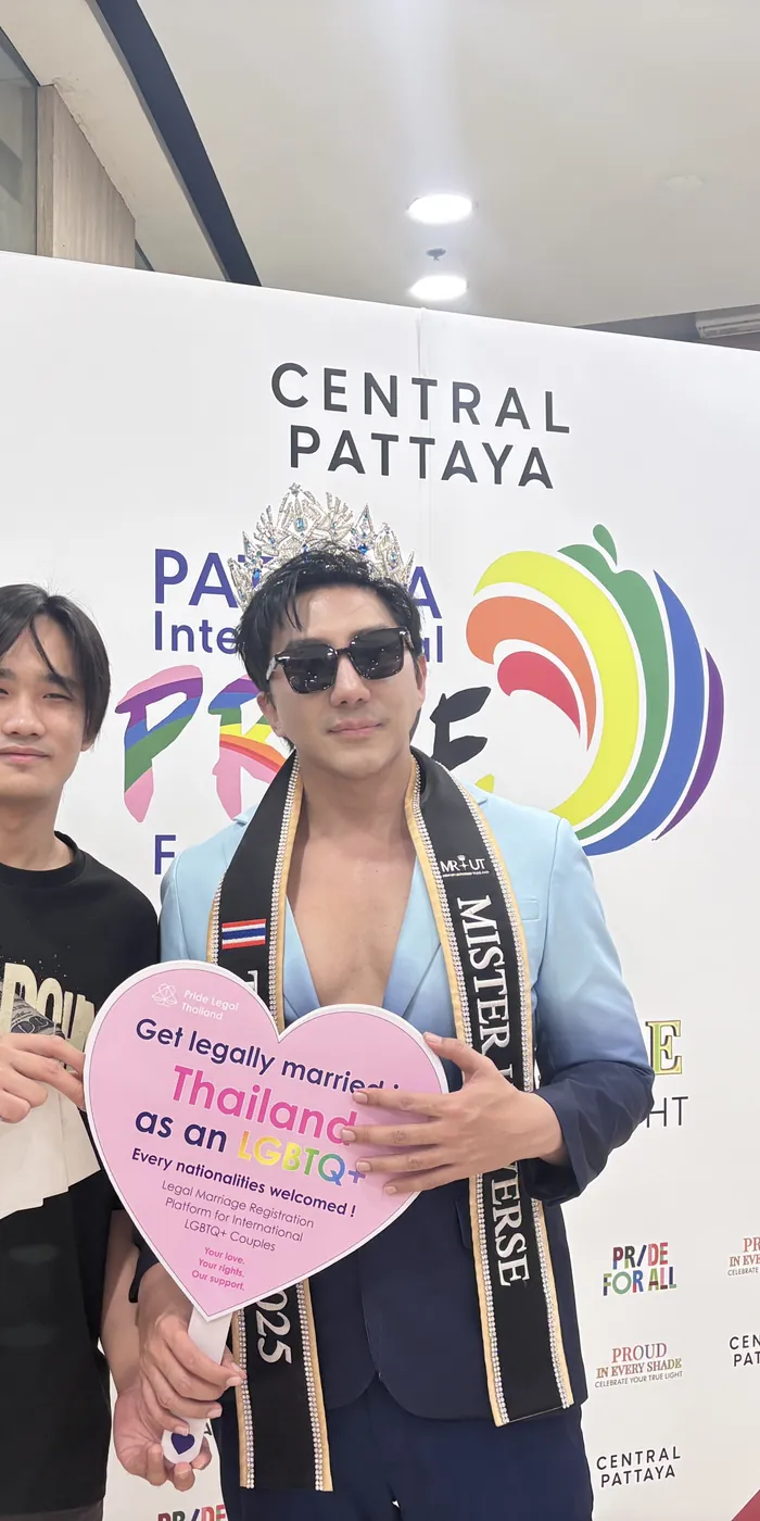 Pageant titleholder holding a Pride Legal heart sign